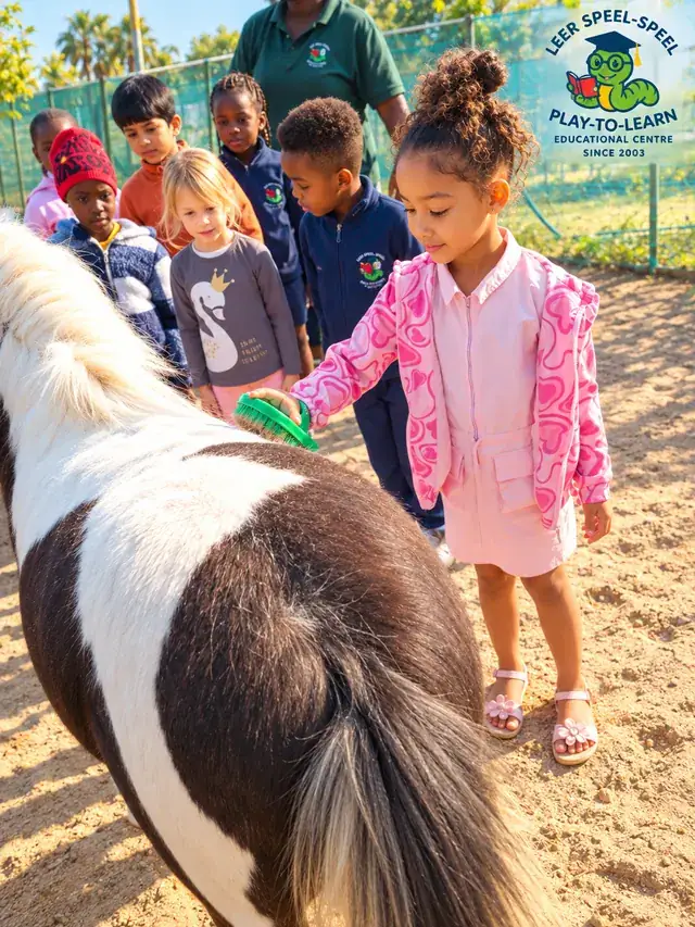 A child brushing a pony while classmates and a teacher look on.